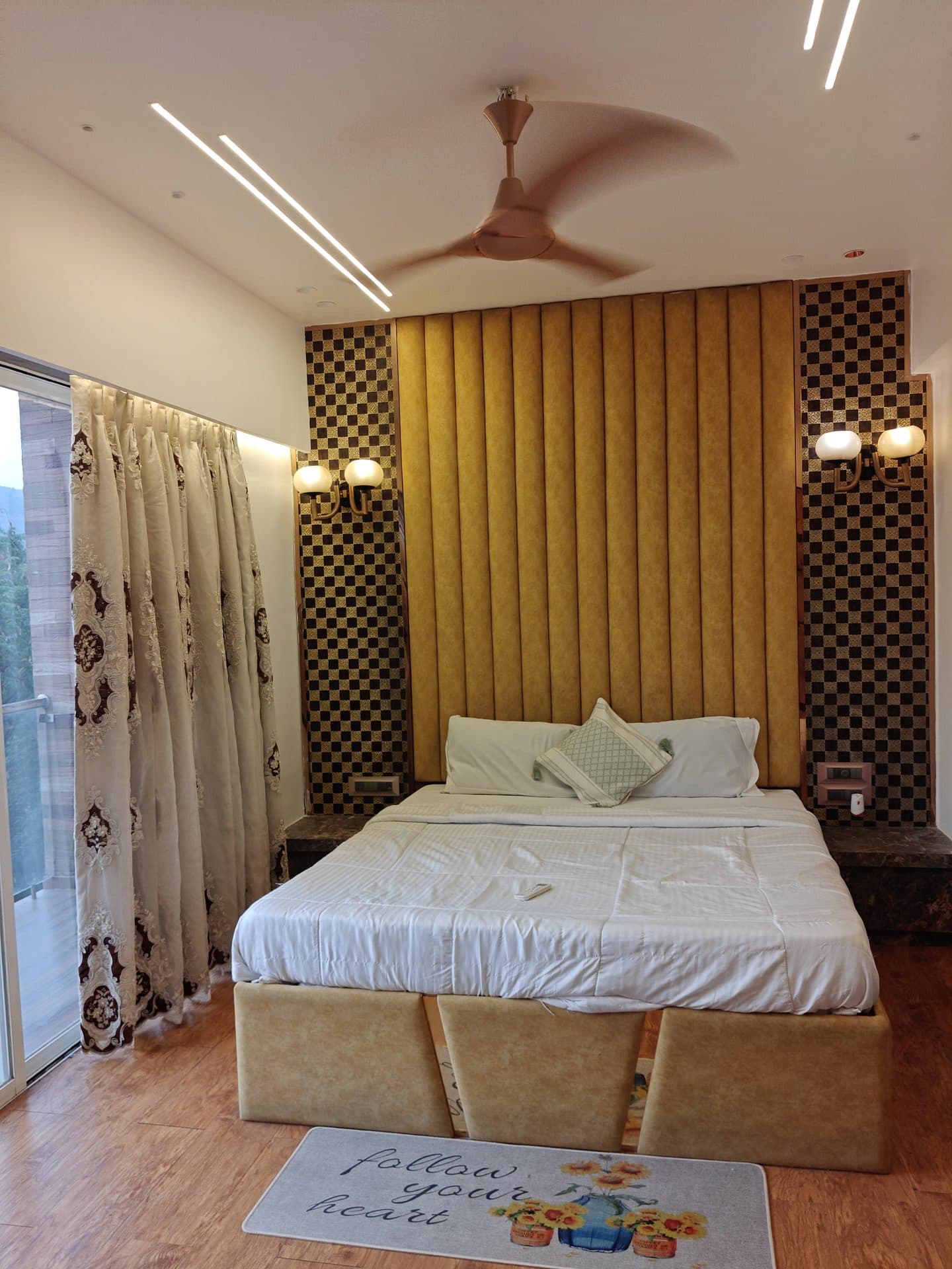 Bedroom with mustard tufted headboard and hillside view