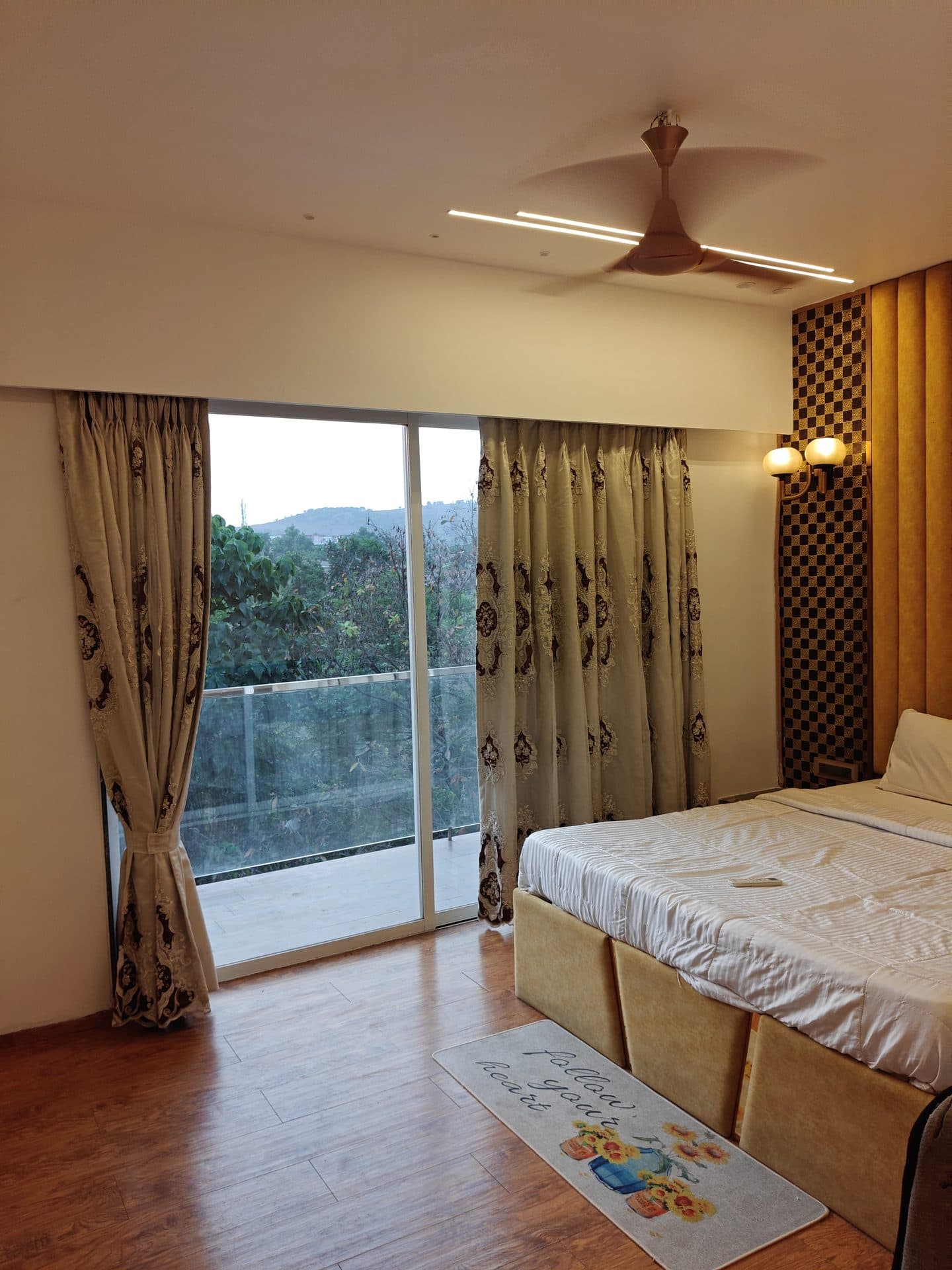 Bedroom with balcony sliding doors and hillside view