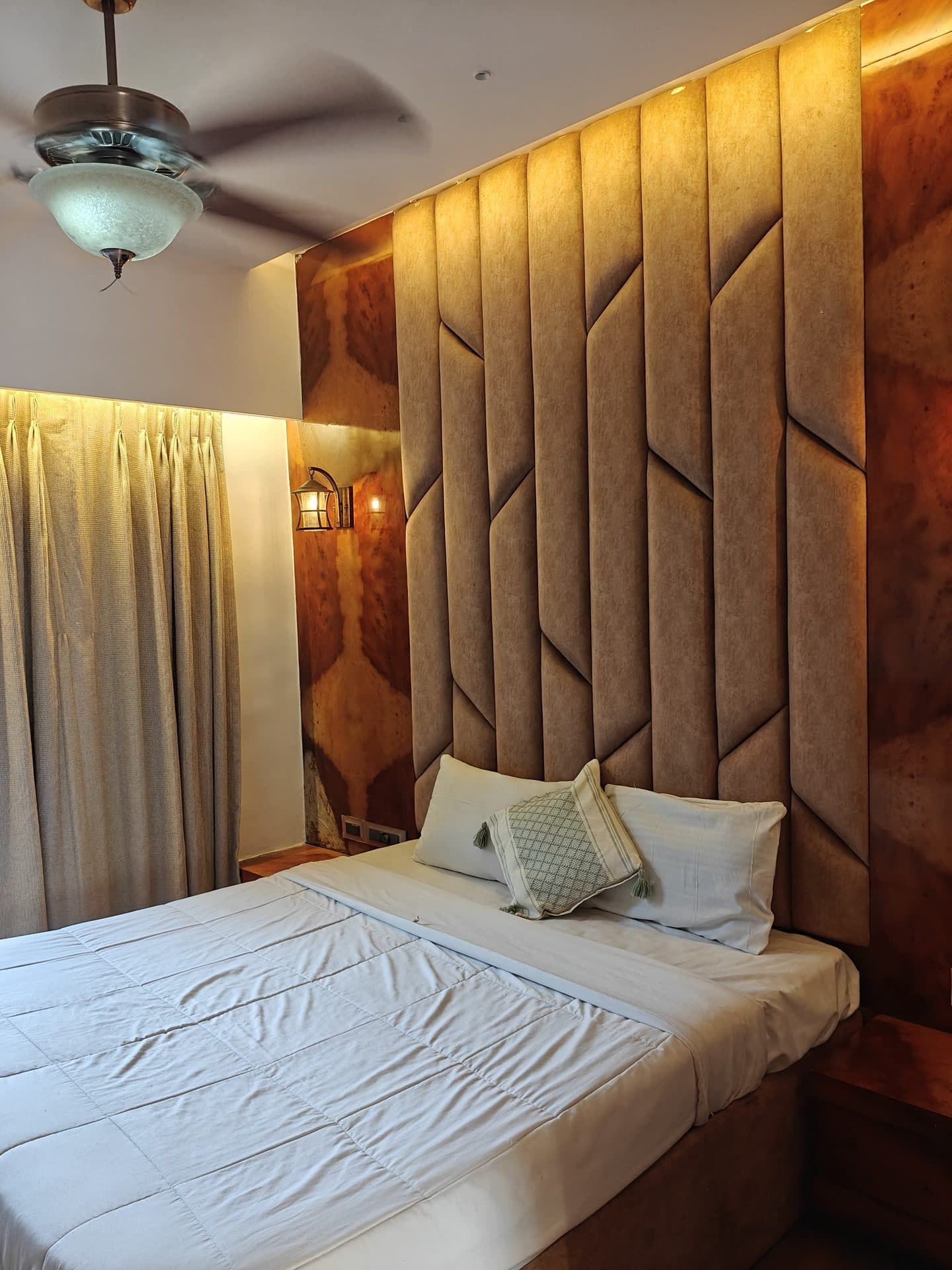 Bedroom with tufted panel headboard