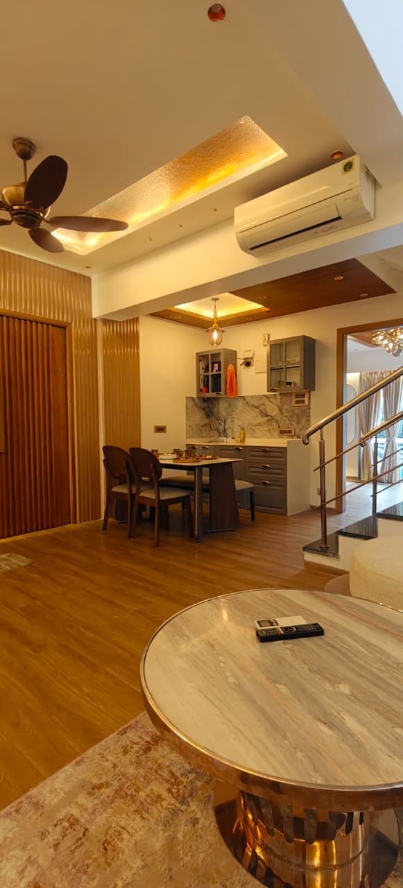 Open-plan kitchen with dining table and staircase