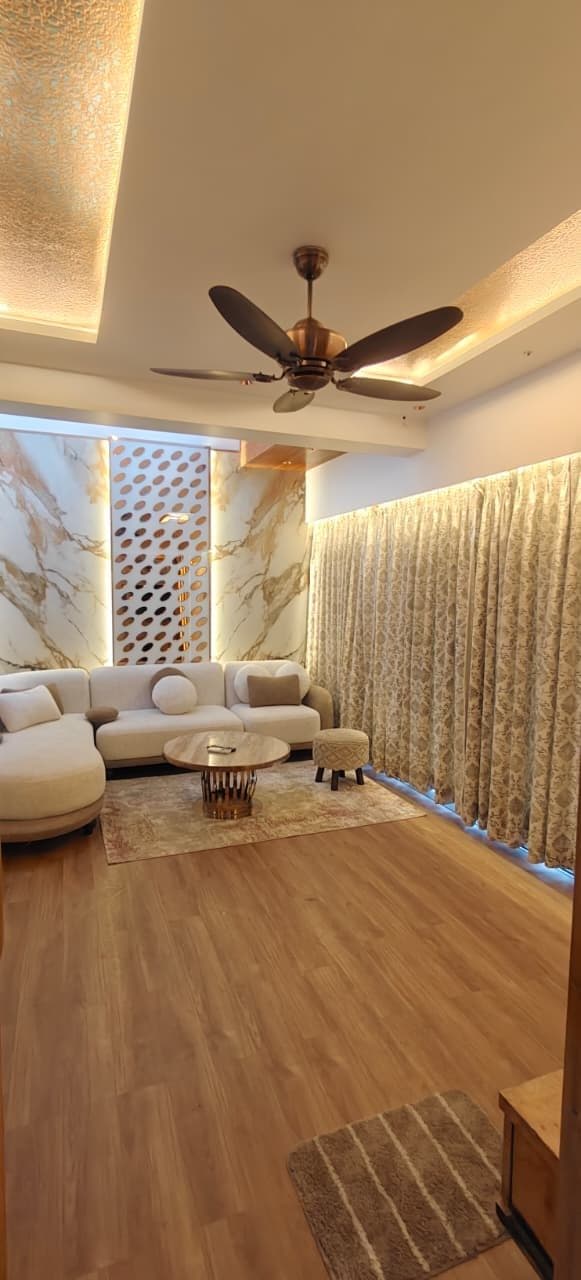 Living room with curved sofa and marble accent wall