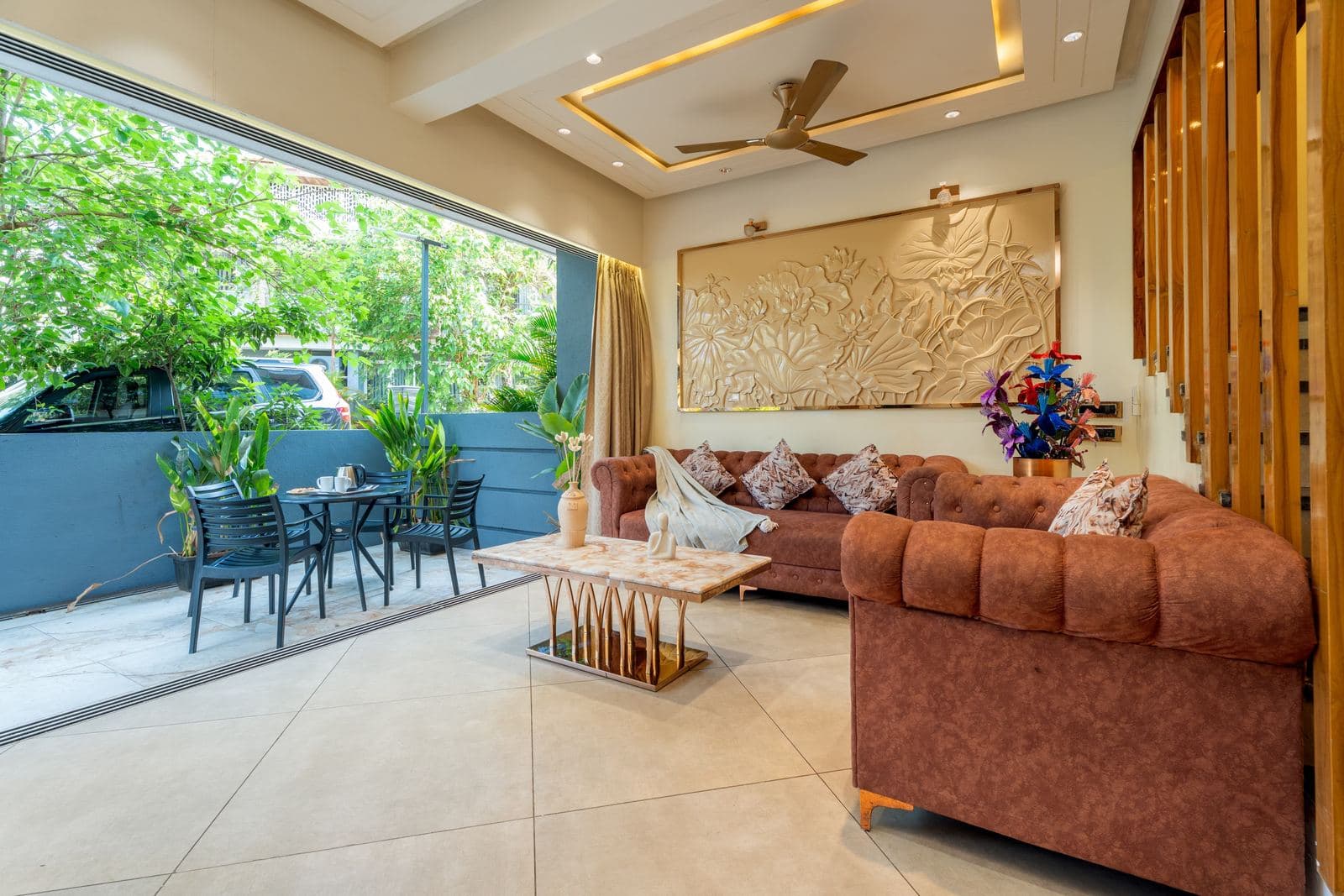 Living room with curved sofa and gold relief wall art