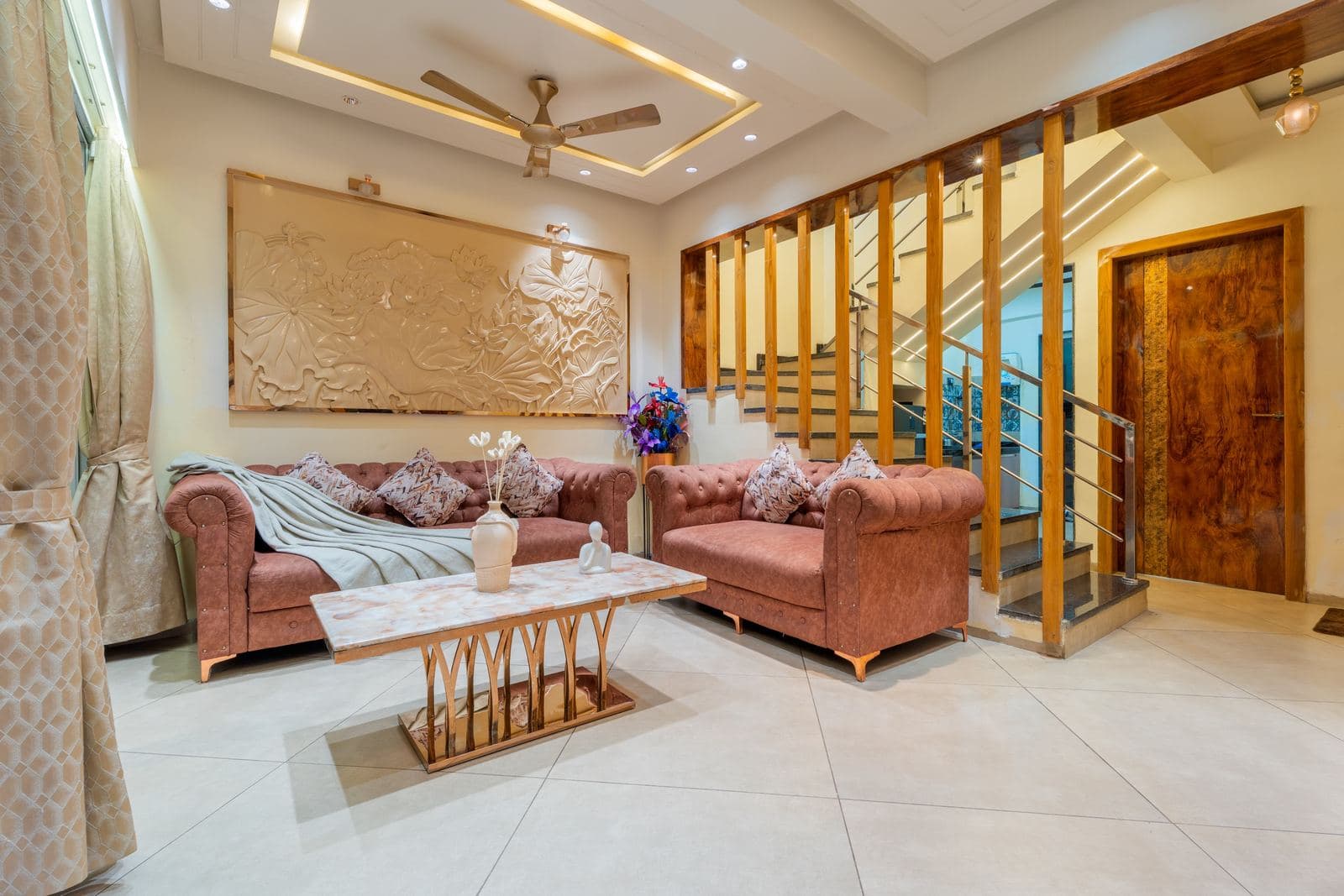 Lounge seating with warm lighting and an open-tread staircase
