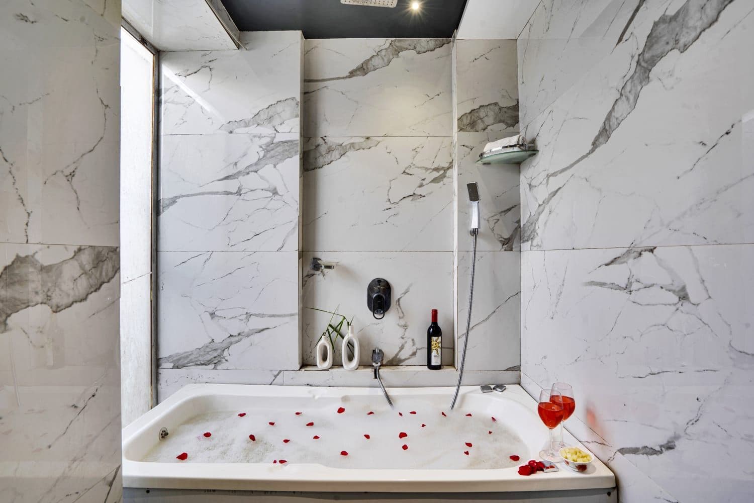 Marble jacuzzi tub scattered with rose petals