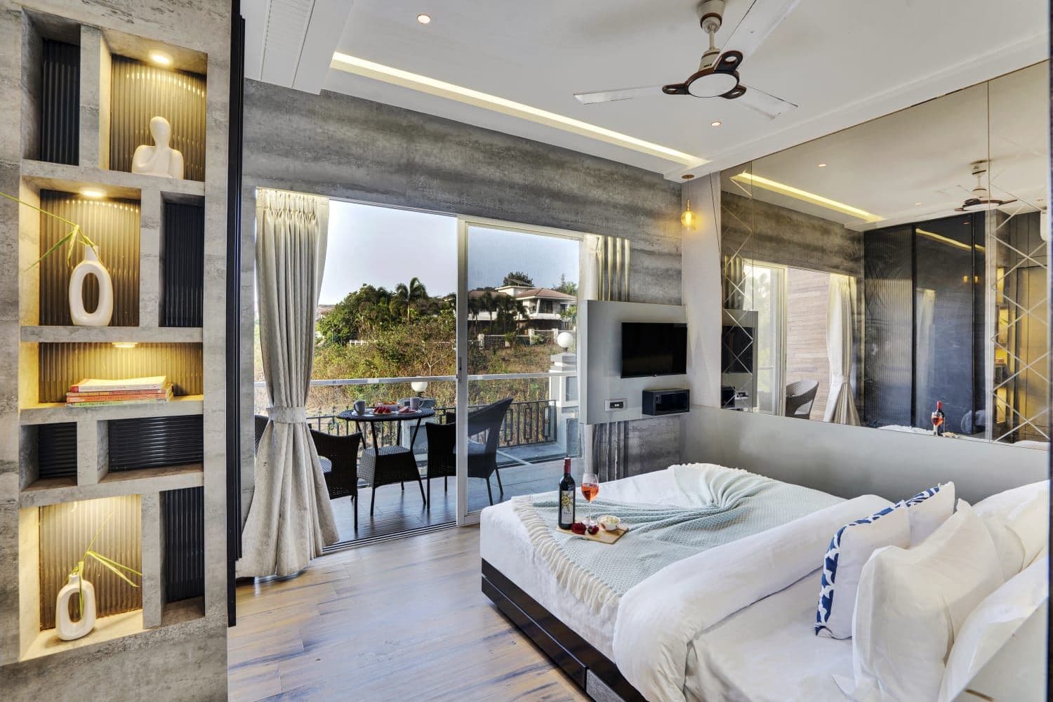 Bedroom with display shelving and sliding doors to outdoor dining area