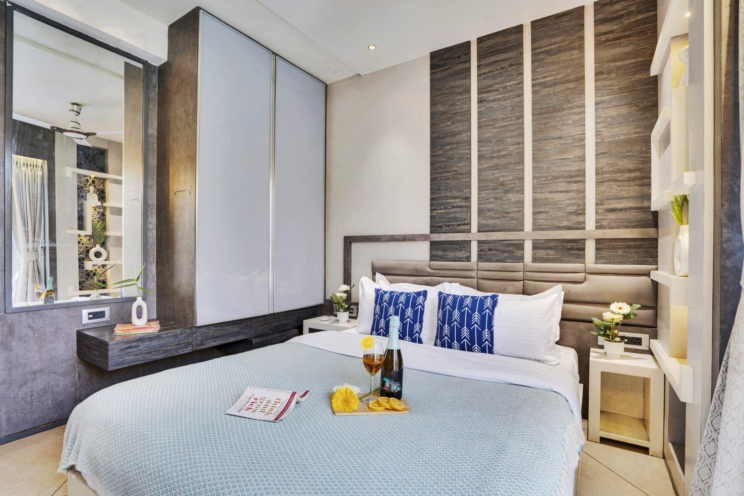 Bedroom with paneled wood headboard wall and mirrored wardrobe