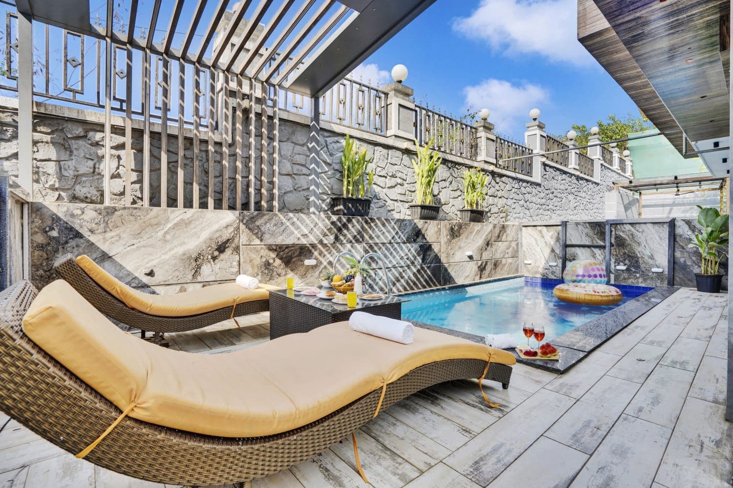 Poolside sun loungers with floating pool ring in daylight