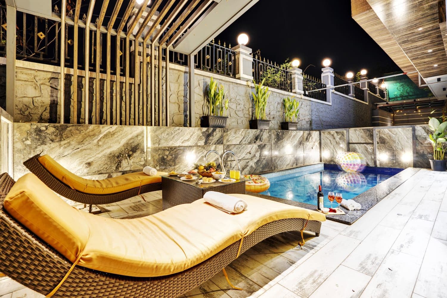 Night-lit poolside loungers with wine service