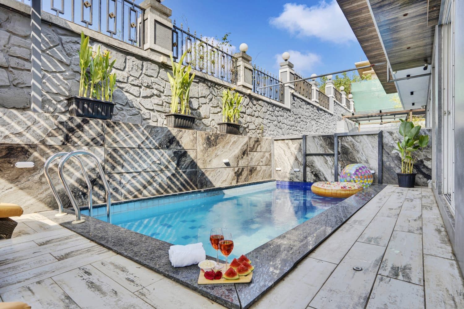 Private pool edge with chilled wine and watermelon platter