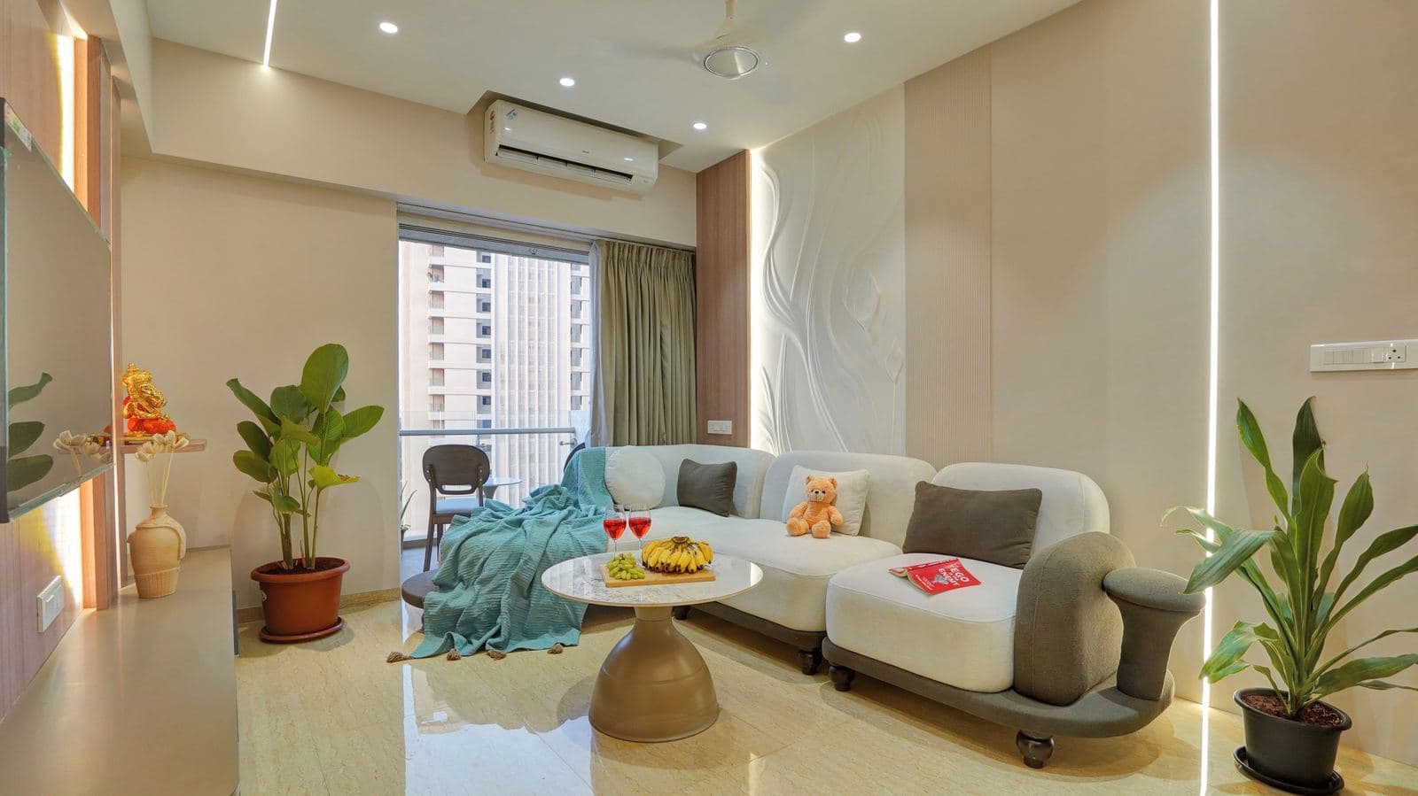 Living room sofa with sculpted wall panel and balcony view