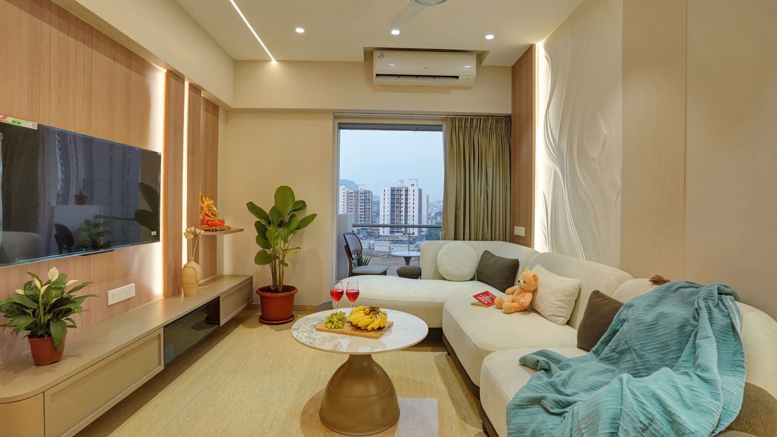 Living room with TV console and city skyline view