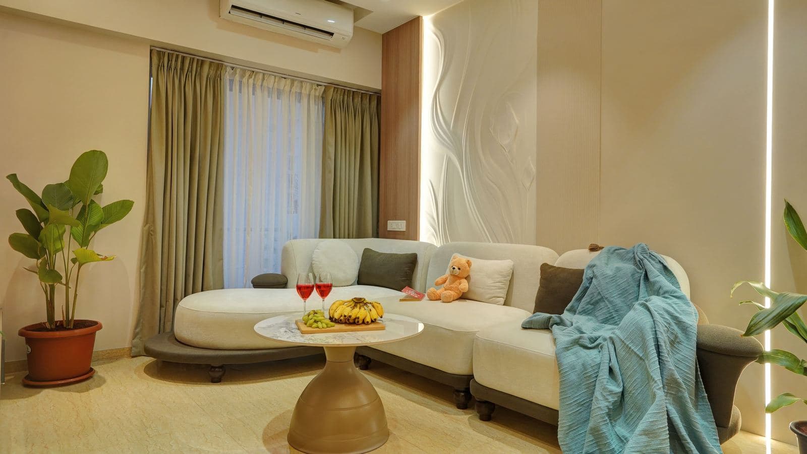 Sofa with draped throw beside a curtained window
