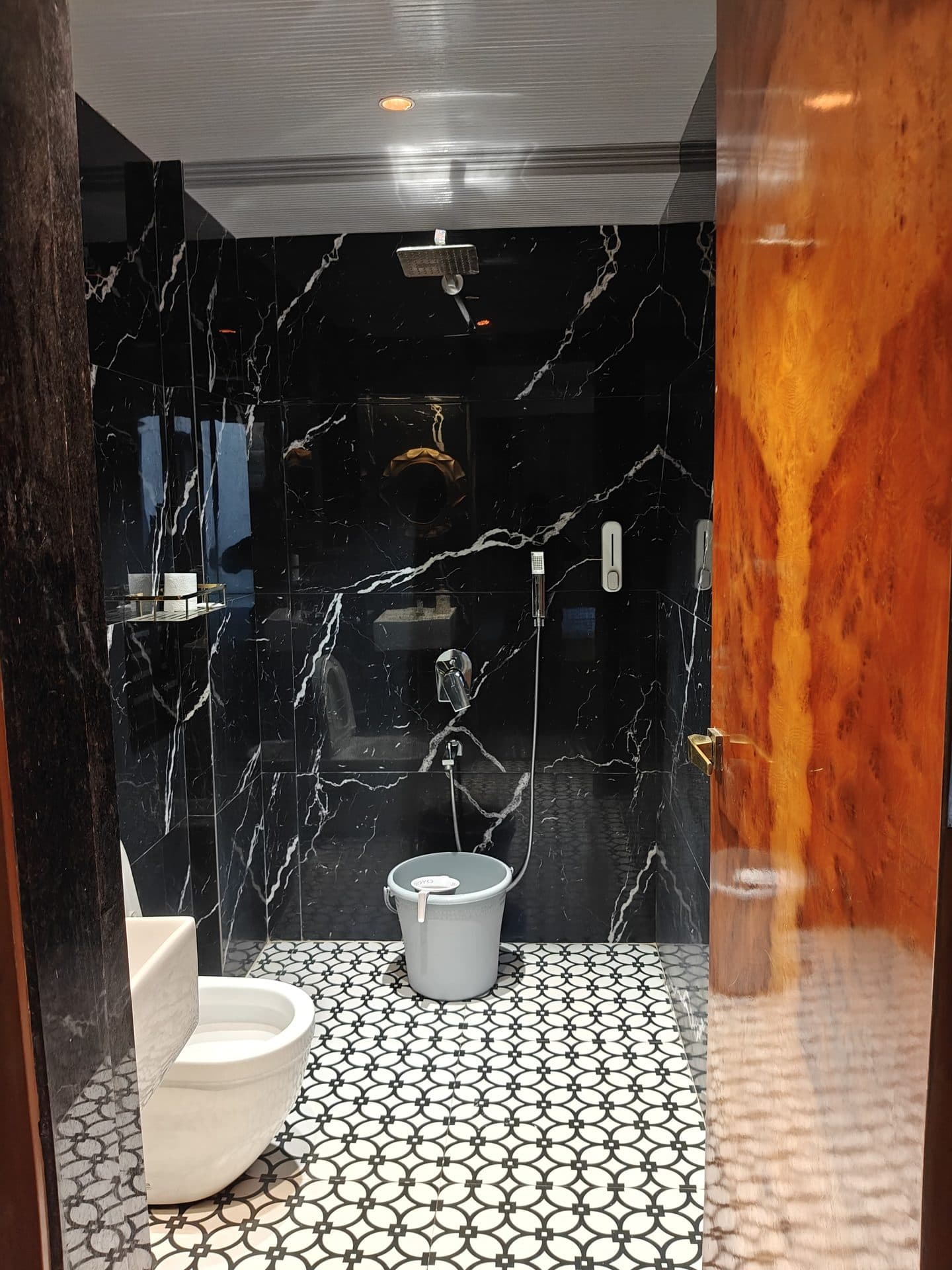 Black marble bathroom with rain shower
