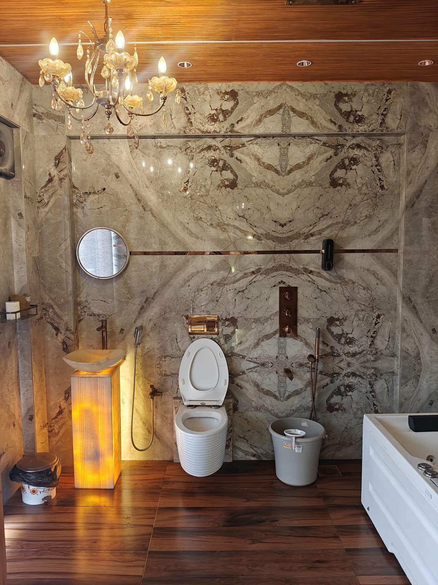 Marble bathroom with wood flooring