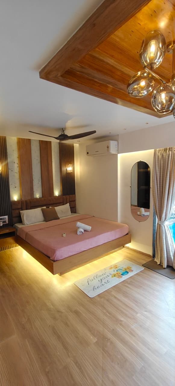 Bedroom with pink bed and warm LED lighting