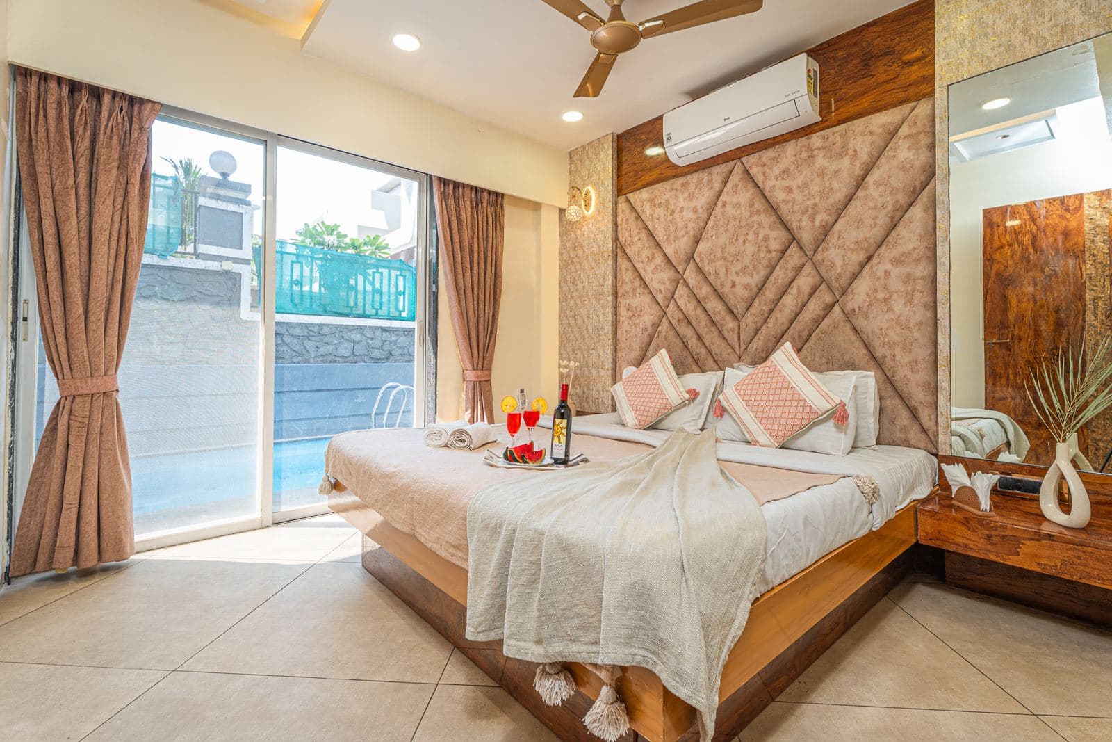 Bedroom with diamond-tufted headboard and balcony sliding doors