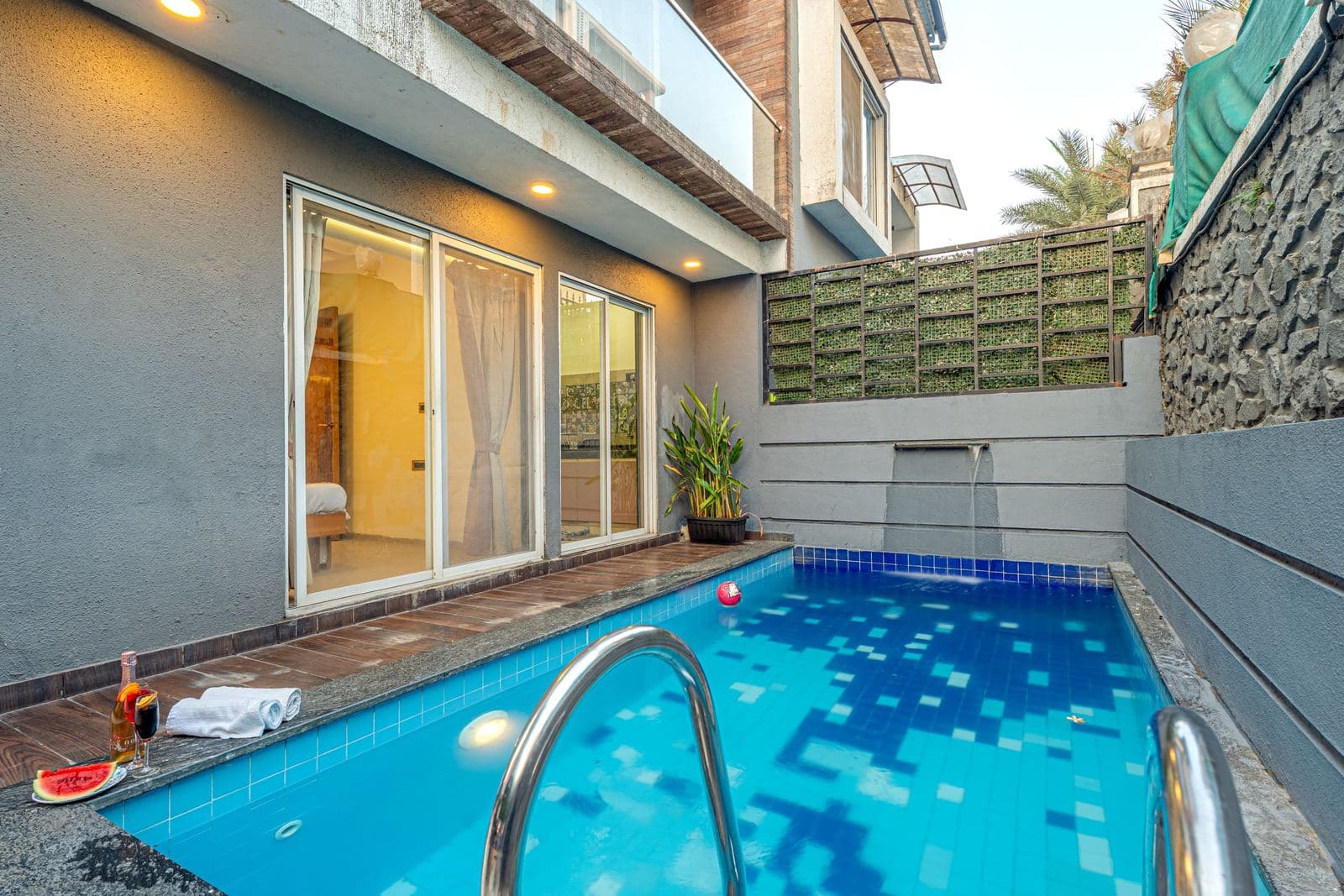 Plunge pool with sliding glass doors opening from the bedroom