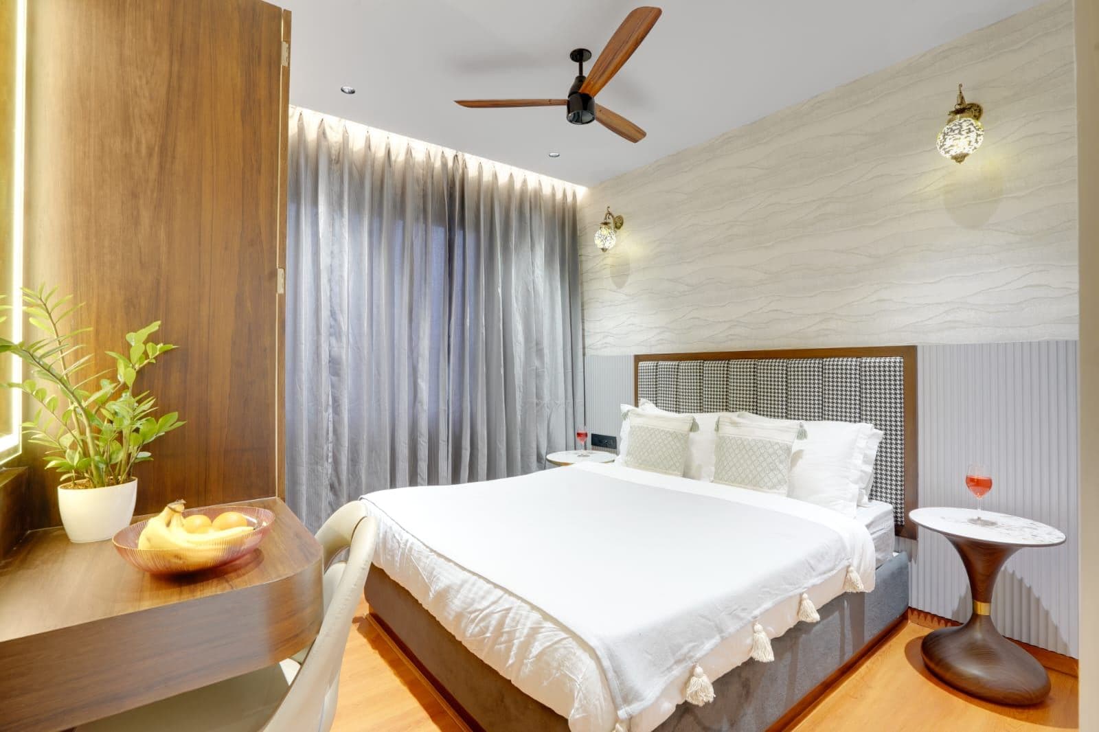 Bedroom with houndstooth headboard and wave-textured accent wall