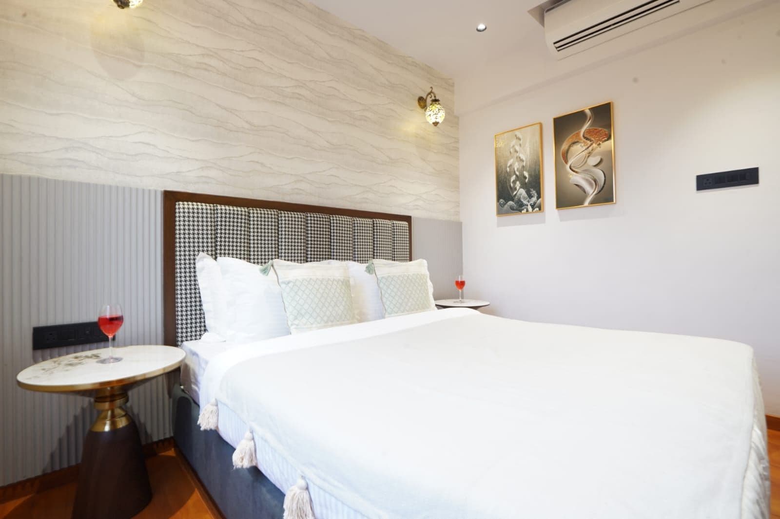 Bedroom bed facing floor-to-ceiling sliding doors that open to the balcony and skyline