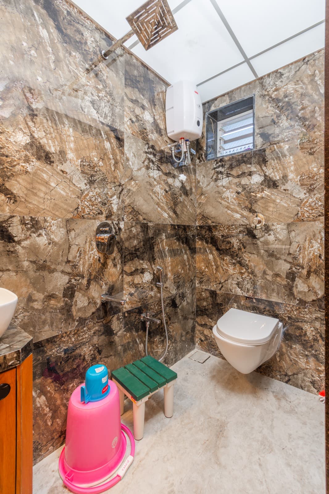 Marble bathroom with wall-mounted toilet