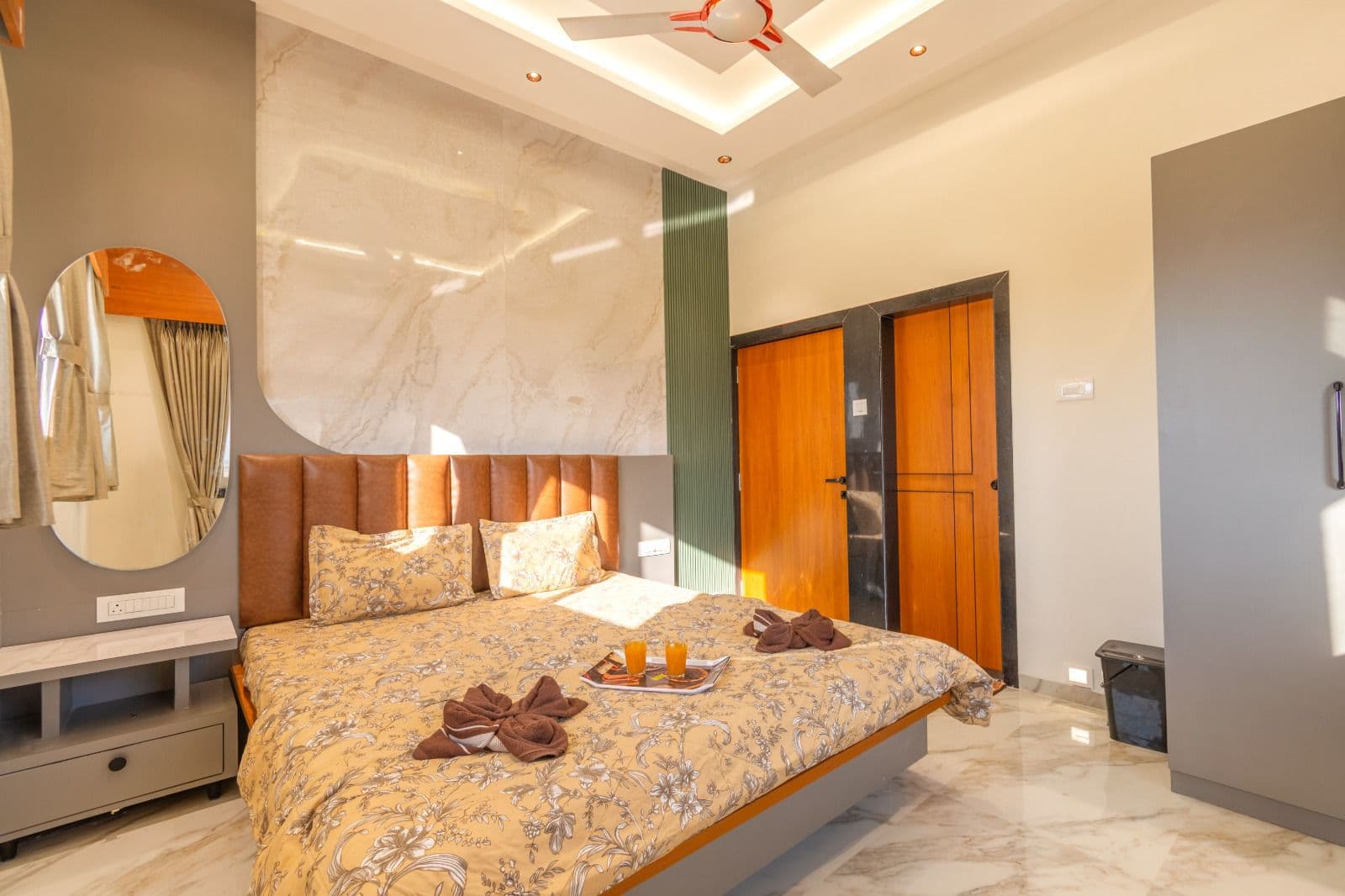 Bedroom with tufted leather headboard and welcome drinks tray