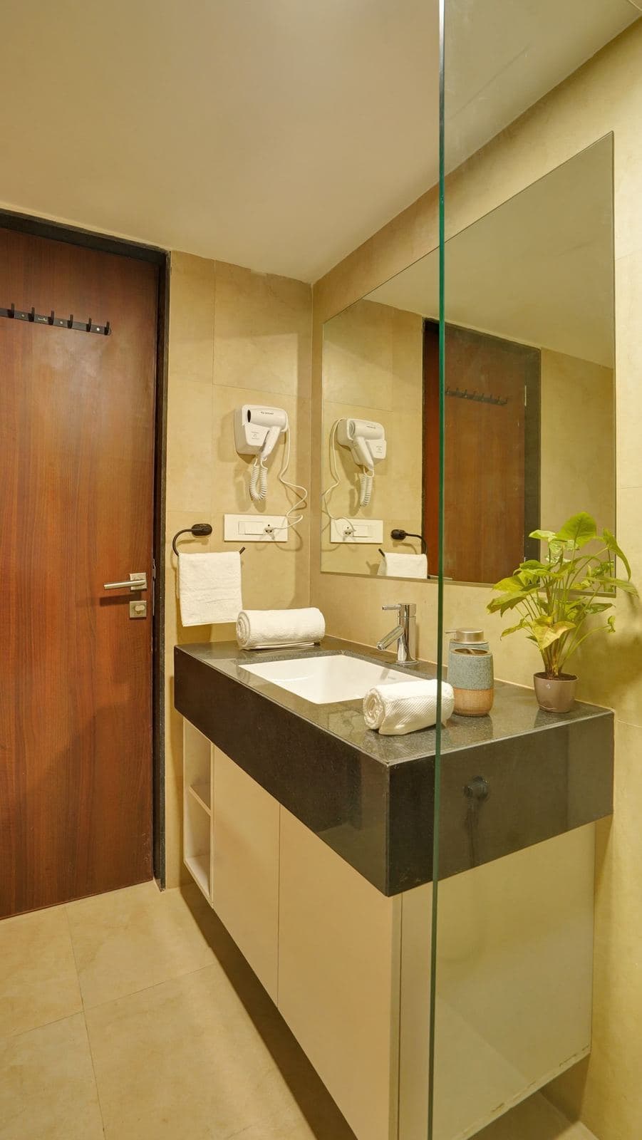 Bathroom vanity with mirror, sink, and wall-mounted hairdryer