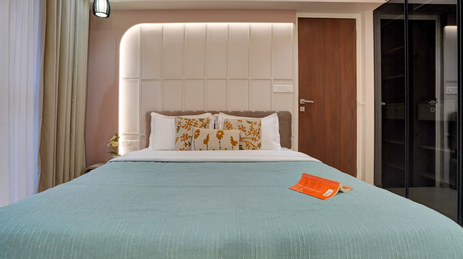 Bed with tufted headboard and patterned cushions
